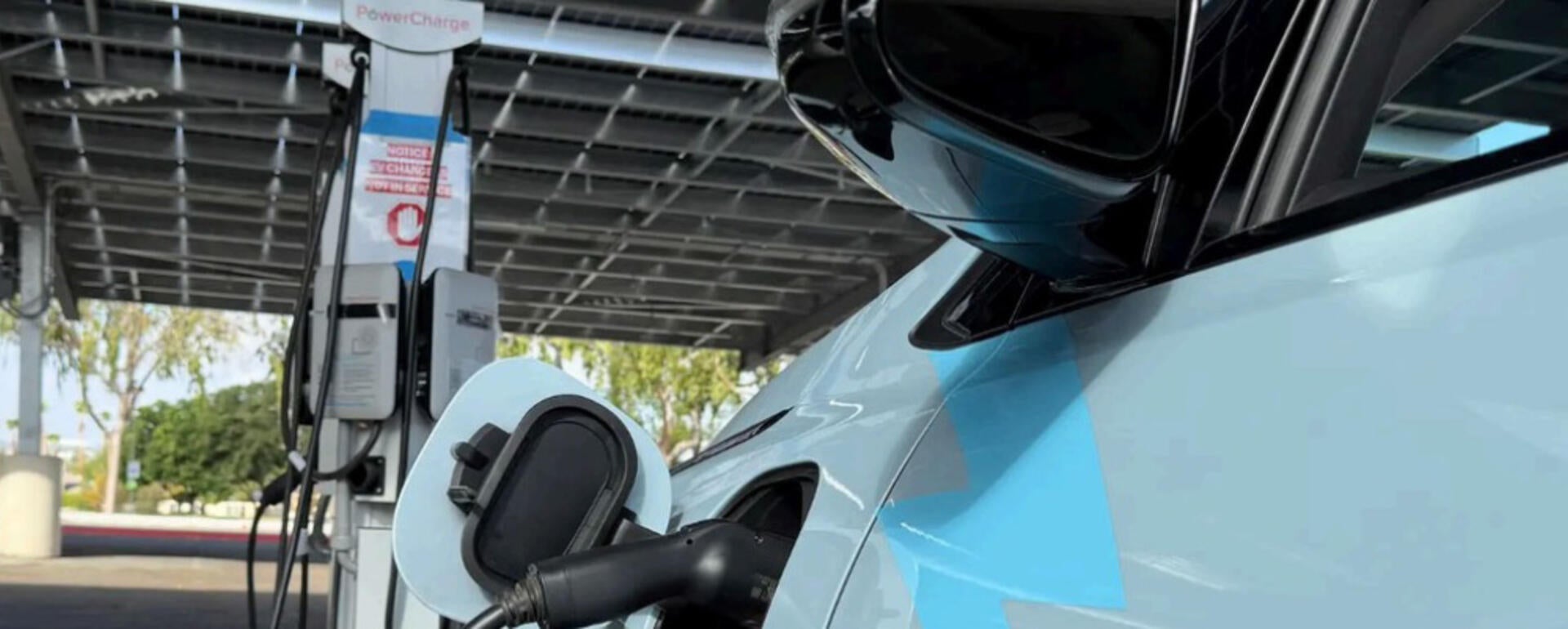 Eco car hooked up to charging station